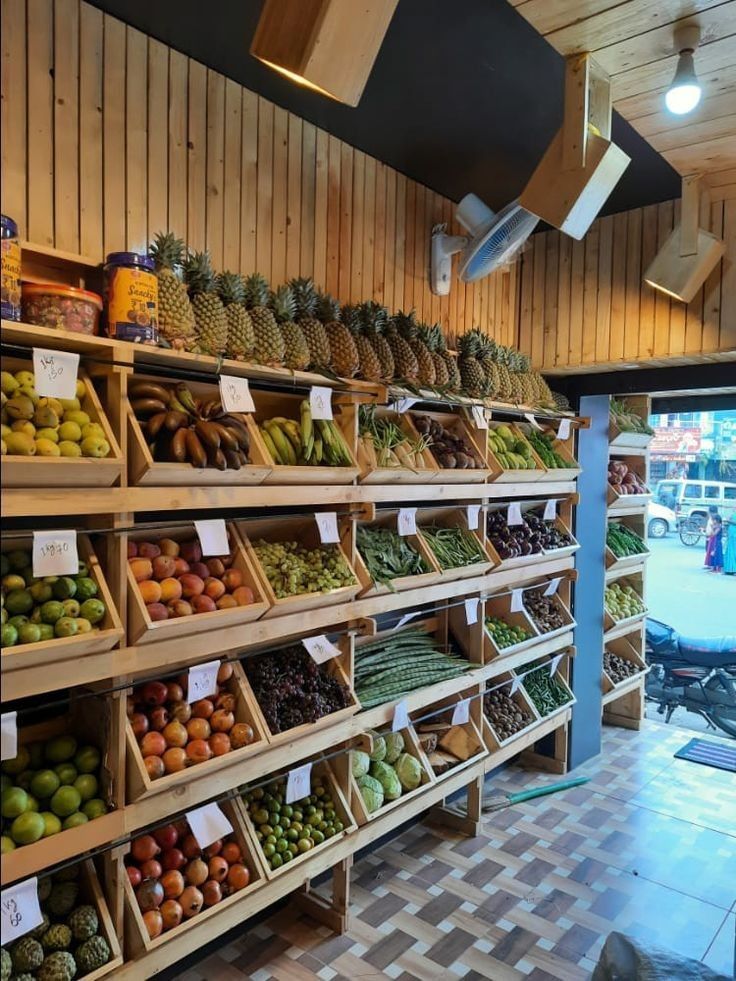 a store filled with lots of different types of fruits and veggies on shelves