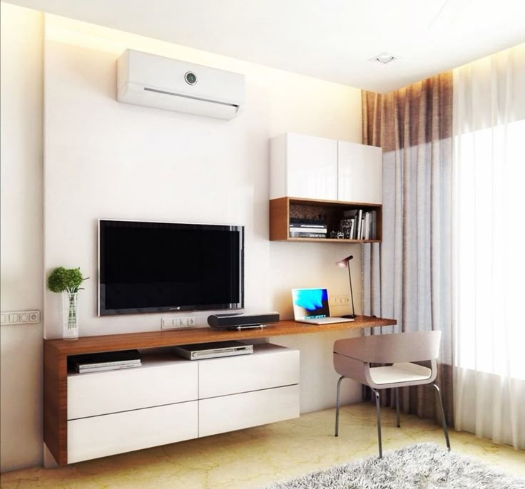 a flat screen tv sitting on top of a wooden entertainment center next to a window