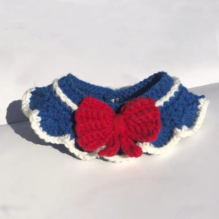 a red, white and blue crocheted bow tie on top of a headband