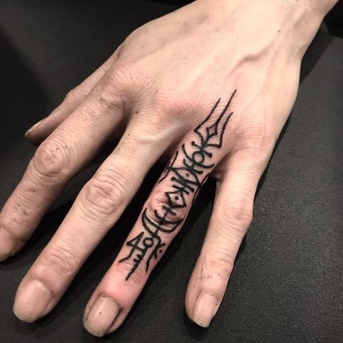 a person's hand with a tattoo on it