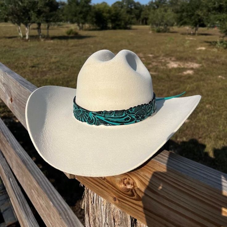 Genuine leather hatband in teal blue color. This hatband is adjustable with leather ties. Adjustable Wide Brim Hat With Leather Sweatband, Adjustable Turquoise Hat Bands For Country Events, Tooled Leather Hat Band, Adjustable Leather Hat Bands For Kentucky Derby, Adjustable Leather Country Felt Hat, Adjustable Felt Hat For Kentucky Derby Country Events, Kentucky Derby Adjustable Leather Hat Bands, Adjustable Turquoise Country Hat, Adjustable Country Style Turquoise Hat