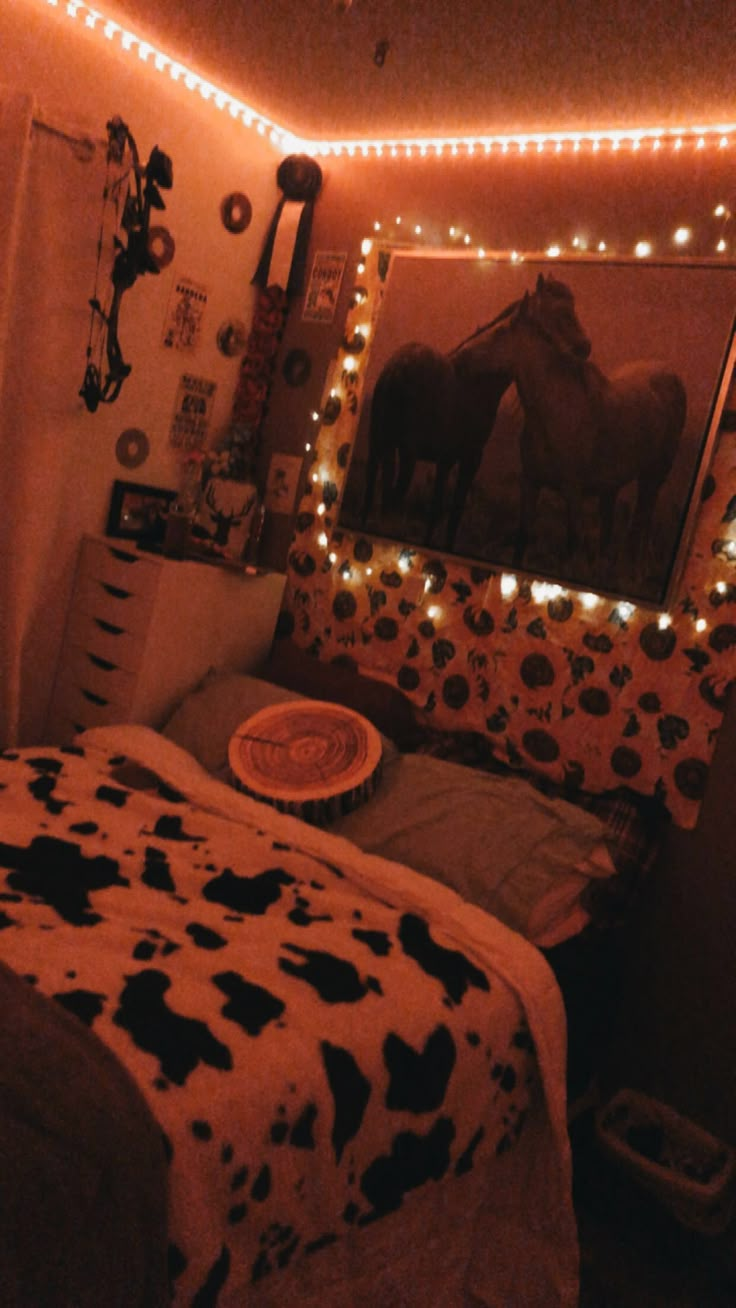 a bedroom decorated in cow print and lights