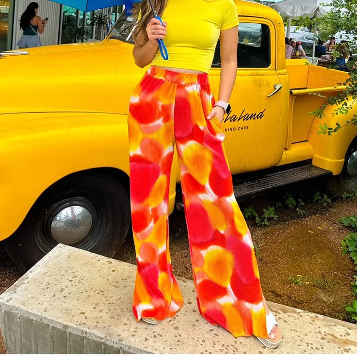 The Cutest & Comfiest Pants You Will Ever Find!!! The Shades Of Orange And Yellow Give Major Sunset Vibes And Can Be Styled With So Many Colors!! We Love Pairing Them With Pinks, Greens, And Yellows But Truly They Go With Every Color!! Style Them With A Sweatshirt For A Casual Day Or A Cute Blouse When Meeting Friends For Brunch! True To Size With A Stretchy Waistband 100% Polyester Soft And Comfy Pants! Style With Yellows, Pinks, Greens, And Purples Dress Up With A Blouse Or Keep It Casual With Vibrant Orange Bottoms For Vacation, Vibrant High Waist Summer Bottoms, Orange Wide-leg Summer Bottoms, Vibrant High-waist Summer Bottoms, Summer Orange Wide-leg Pants, Yellow Wide Leg Pants With Elastic Waistband, Orange Wide-leg Pants For Summer, Orange Wide-leg Summer Pants, Summer Orange Pants With Pockets