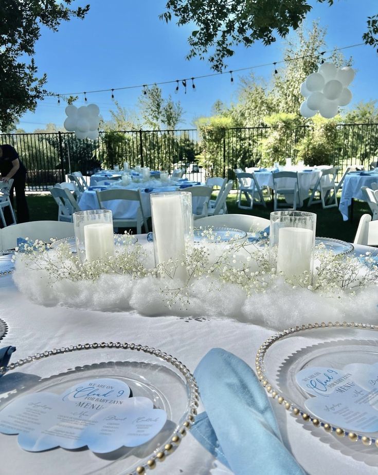 the table is set with candles, plates and napkins for an elegant wedding reception