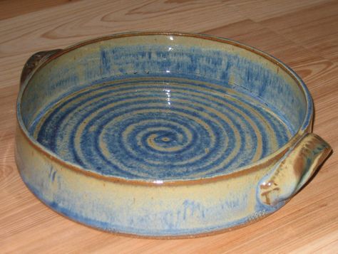 a blue and white bowl sitting on top of a wooden table