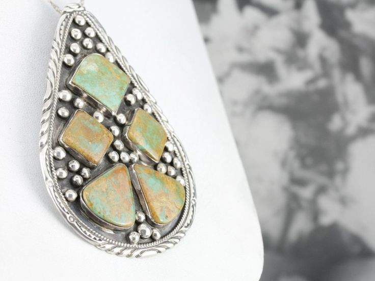 This vintage pendant is a work of art, a great example of Native American design at it finest, featuring bold geometric gemstones. Polished cabochons of perfectly matched green turquoise, sized for a man or women, this would make a great addition to your collection of Native American jewelry! This piece is part of a set featuring an oversized brooch, a perfect complement to this fantastic pendant Sku# E8DL49 This pendant does not come with the chain shown. Please feel free to contact us, we will Southwestern Multi-stone Green Jewelry, Southwestern Green Multi-stone Jewelry, Southwestern Style Green Multi-stone Jewelry, Green Southwestern Style Jewelry With Inlay, Southwestern Style Green Inlay Jewelry, Southwestern Green Necklace With Large Pendant, Southwestern Style Green Necklace With Large Pendant, Green Artisan Oval Pendant Jewelry, Artisan Green Oval Pendant Jewelry