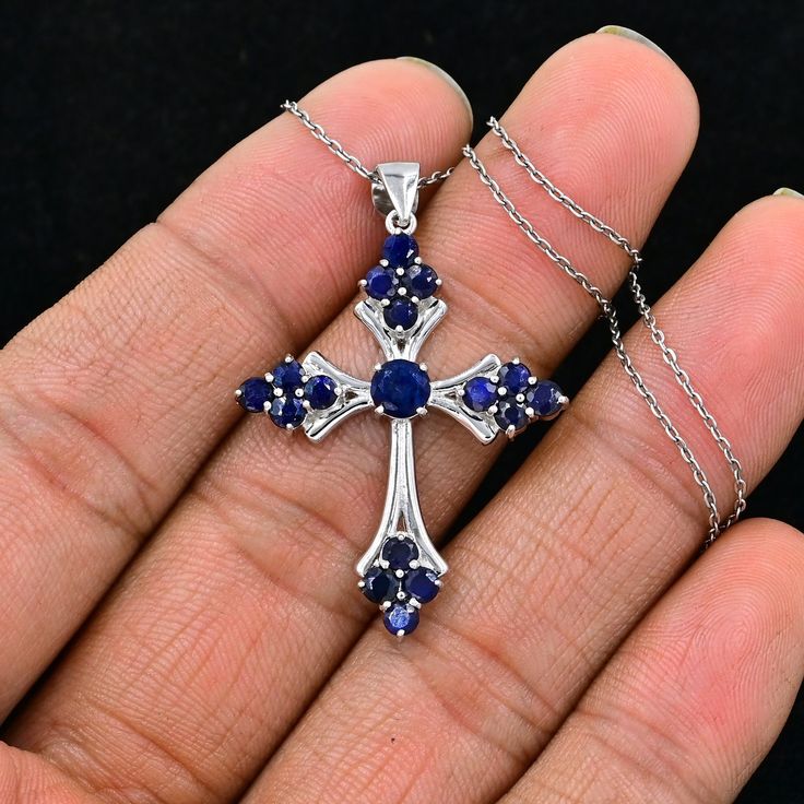 "925 Sterling Silver, Natural Sapphire Cross Pendant, Holy Cross Pendant Necklace, September Birthstone, Sapphire Jewelry, Gift For Birthday.  ►Made of solid sterling silver with a rhodium finish (925) ● Code --- HC-195 ● Main Stone --- Natural Blue Sapphire ● Birthstone Month --- September ● Color --- Blue ● Gem Size --- 3 MM/3 MM ● Carat Weight --- 3.10 ct. (approx.) ● Total Weight --- 5.95 Gram ● Gemstone Creation --- 100% Natural ● Accented Stone --- White Topaz ● Pendant Length --- 1.60 Inch ● Pendant Width --- 1.10 Inch Some of the amazing additional features of this product: ● Fine, professional cut natural gemstones - not synthetic, lab created, nor simulated ● Elegant, makes beautiful engagement gift; anniversary gift; bridesmaid gift; gift for girlfriend; gifts for mom; gift for Fine Jewelry Sterling Silver Cross, Silver Sterling Silver Jewelry For Birthday, Silver Cross Jewelry For Anniversary, Sterling Silver Cross Fine Jewelry, Sterling Silver Hallmarked Jewelry For Birthday, Sterling Silver Pendant Jewelry For Birthday, Silver Sterling Silver Jewelry For Birthday Gift, Silver Gemstone Necklace For Birthday, Sapphire Jewelry Stamped 925 For Anniversary