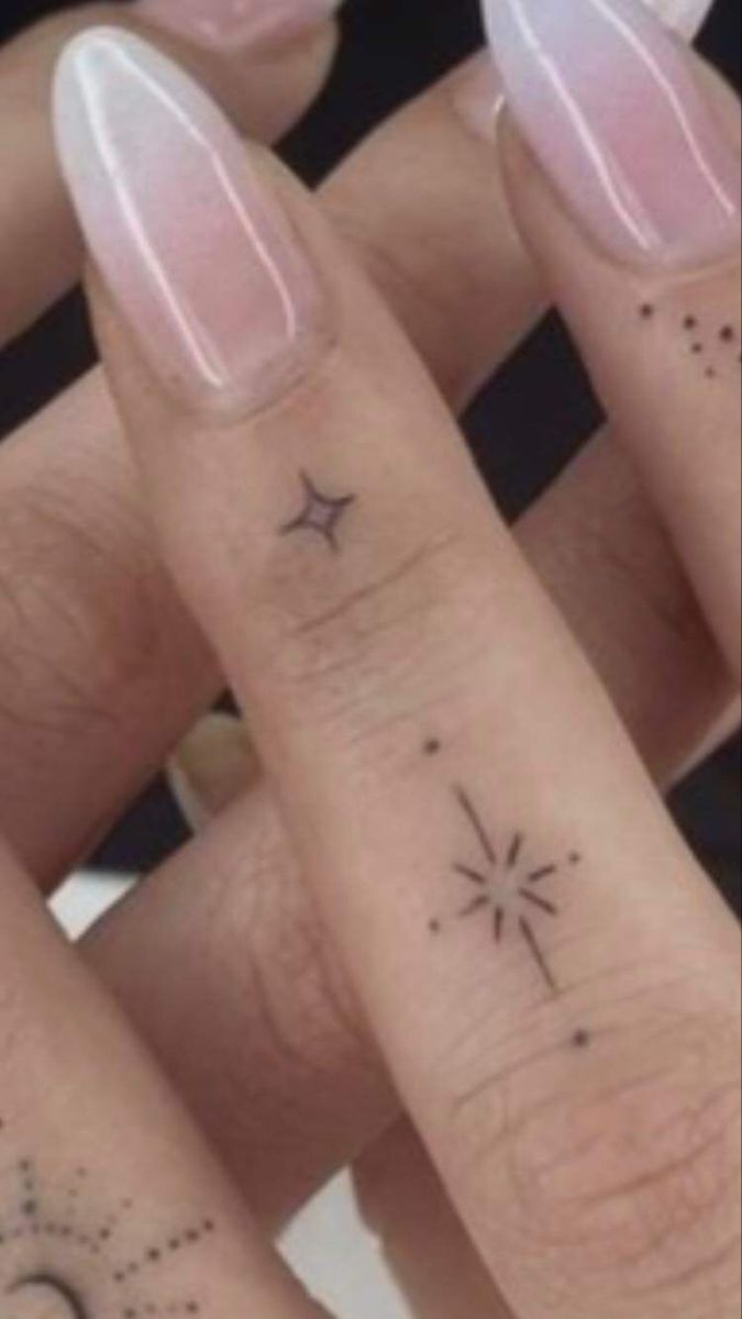 three finger tattoos with stars and moon on them