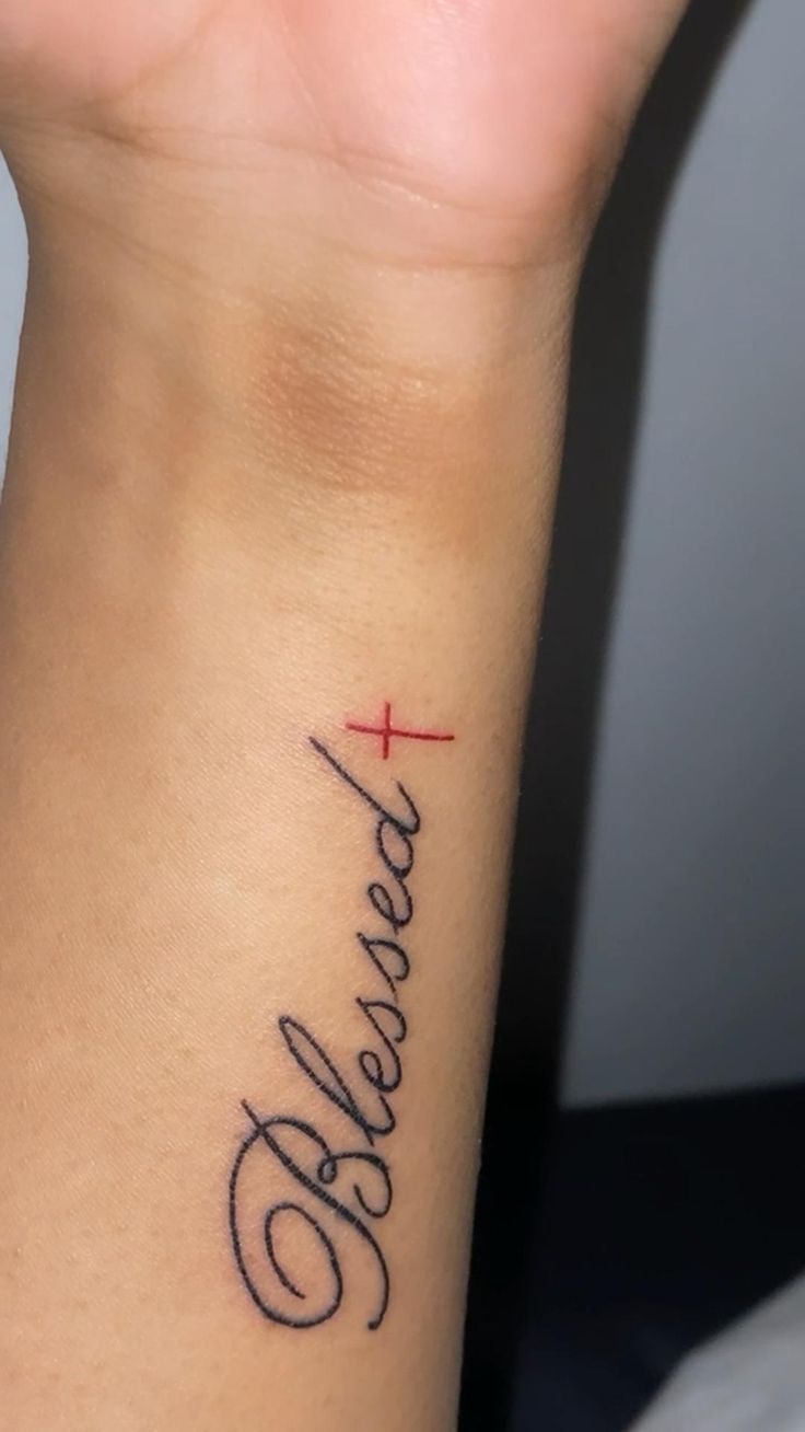 a woman's wrist tattoo with the word believe on it