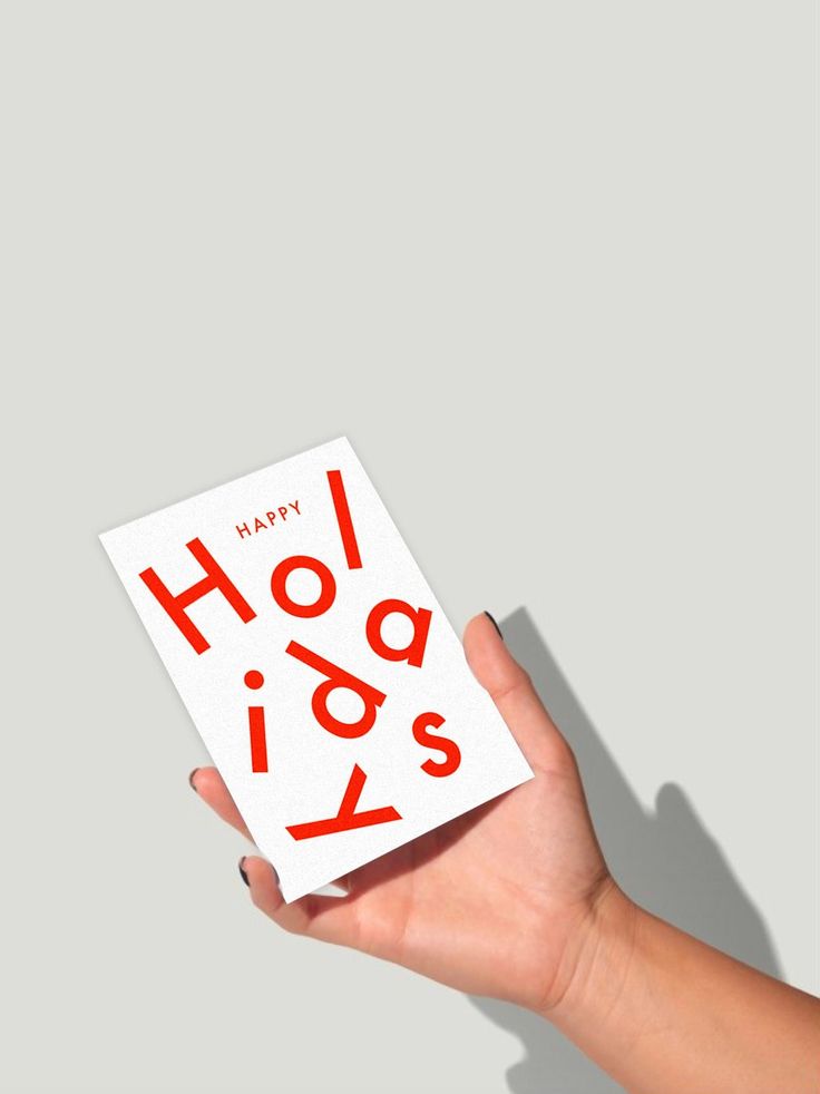 a hand holding a card with the words happy hol o's on it