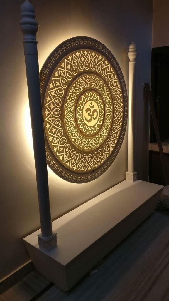 an illuminated wall hanging in the corner of a room with a lamp on top of it