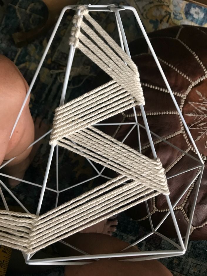 a close up of a metal object on a carpeted floor next to a leather chair