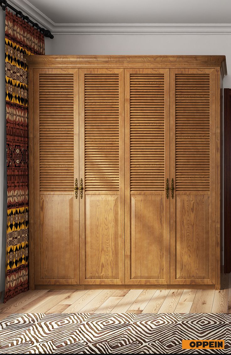 an empty room with wooden closets and zebra rug