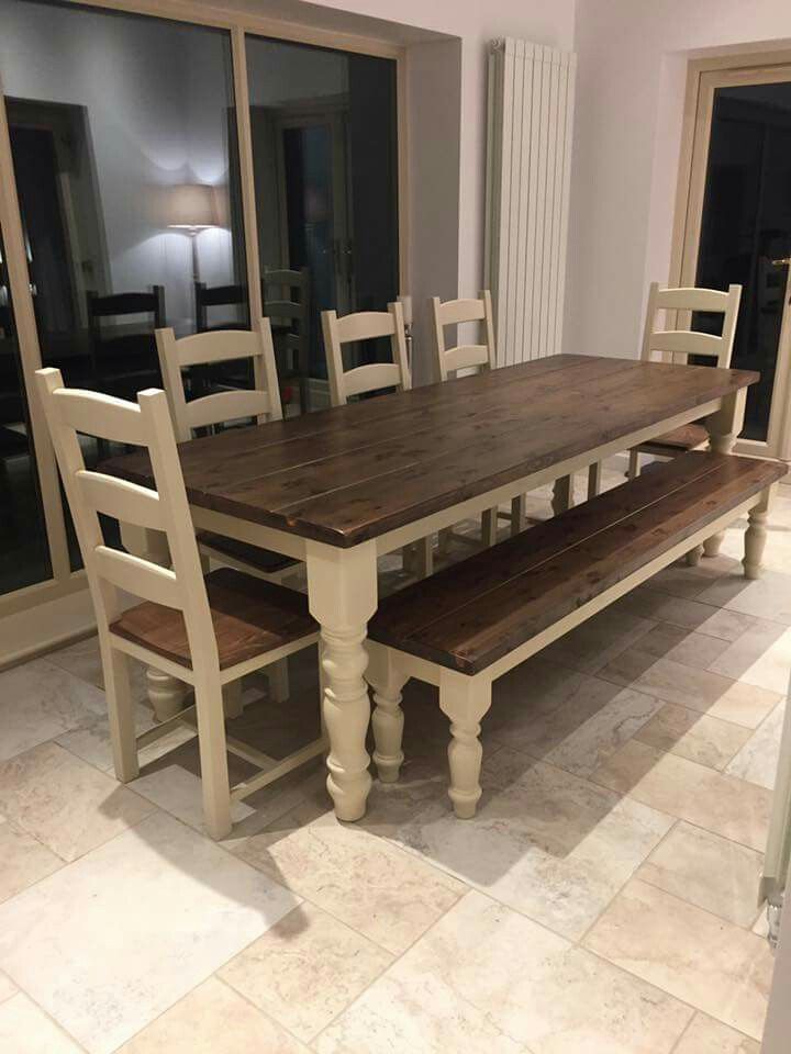 a dining room table and bench in front of sliding glass doors