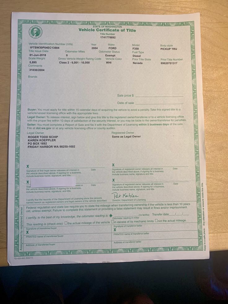 a person is holding up a green certificate