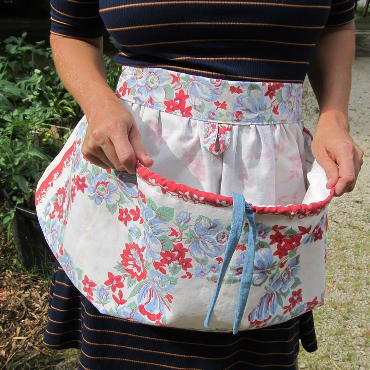 a woman is holding an apron in her hands