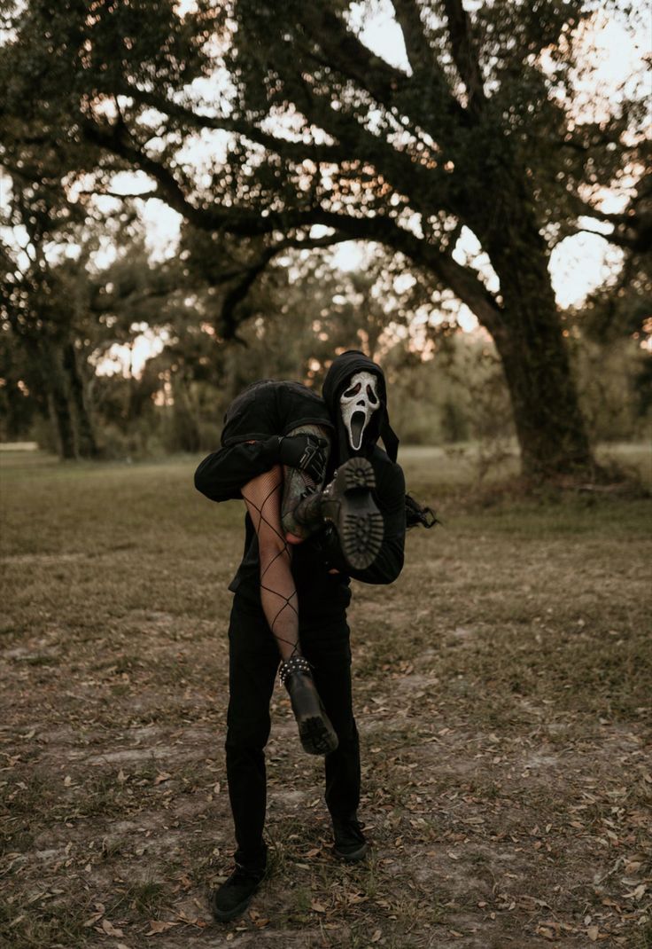 a person in a skeleton mask holding a baseball glove