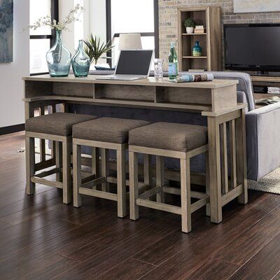 a living room filled with furniture and a flat screen tv on top of a wooden table