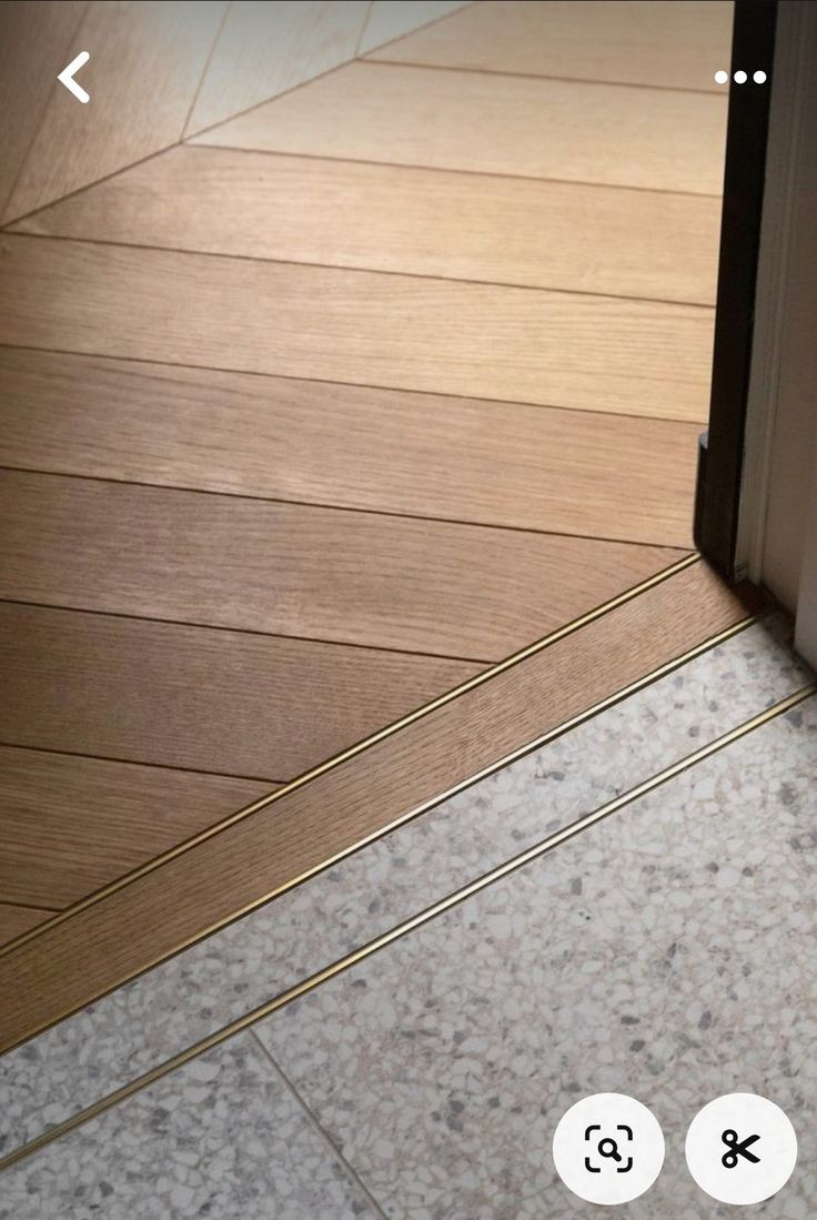 an open door on the floor next to a tile floor with two small white circles