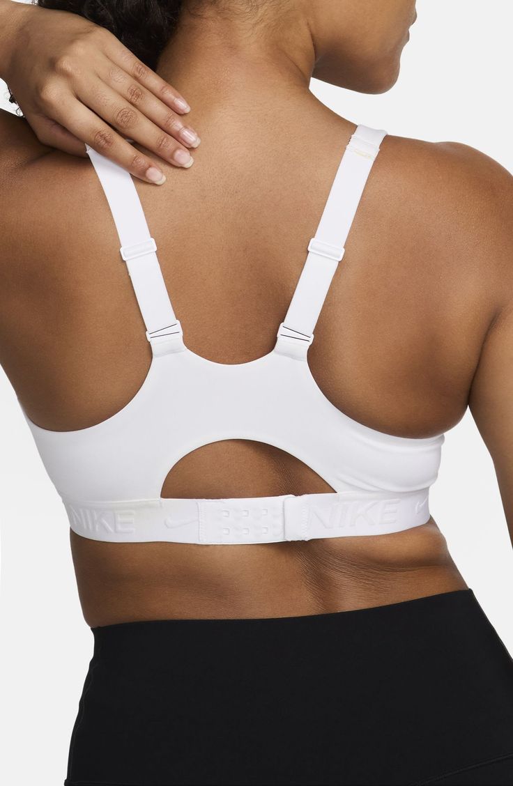 High support and padding minimize movement in this moisture-wicking sports bra, making it ideal for high-intensity workouts and sports. Partially lined Dri-FIT moisture-wicking technology 78% polyester, 22% elastane Machine wash, line dry Imported Padded Medium Support Activewear For Sports, Functional White Sports Bra For Workout, Sports Bra With Arch Support, Padded Sports Bra For Sports Events, White Compression Sports Bra For Light Sports, White Supportive Activewear For Light Sports, White Sports Bra With Light Support, Breathable White Sports Bra For Light Sports, White Activewear With Light Support For Sports