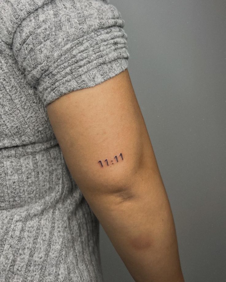 a woman with a small tattoo on her arm