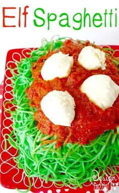 a red plate topped with spaghetti covered in sauce and cheese on top of green noodles