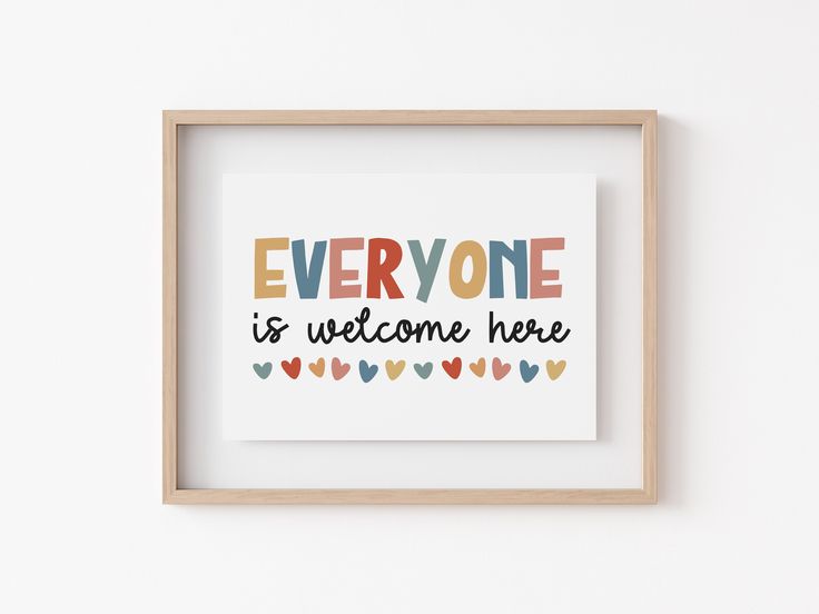 a framed print with the words everyone is welcome here in multicolored hearts on it