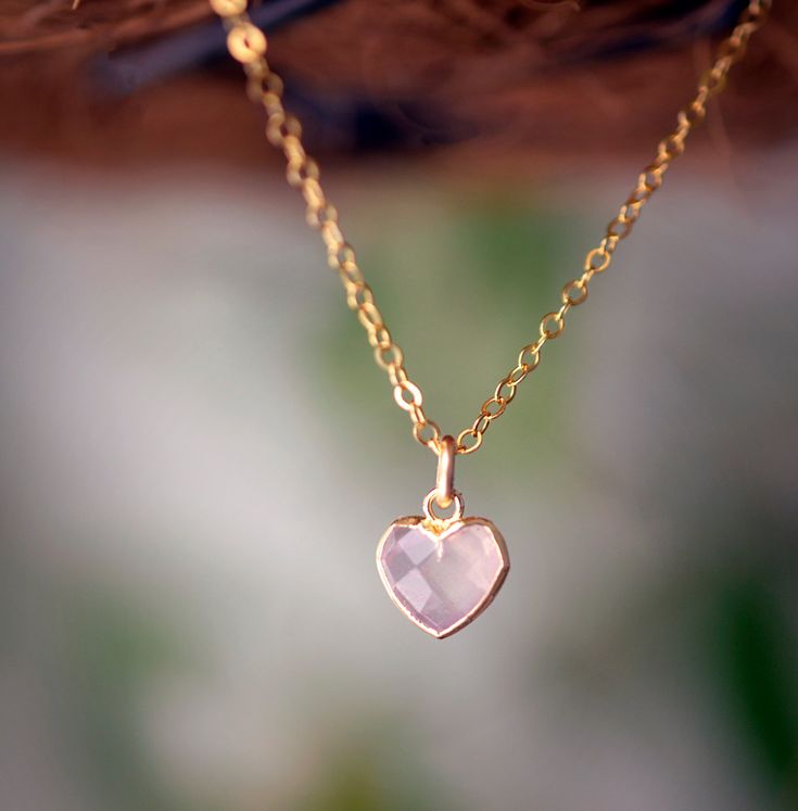 Looking for a unique accessory for some self love, or love for that special someone? Crafted from 14k gold filled and natural Rose Quartz, this pendant is the perfect, sparkling way to show anyone how much you care. Rose Quartz is a stone of love. It is believed to restore trust & harmony in relationships and encourage unconditional love. It purifies the heart and promotes self love, inner healing, and friendship. It is an alternate birthstone for January, as well as the spiritual birthstone for Rose Quartz Heart Pendant, Crystal Heart Pendant, Crystal Formations, Inner Healing, Rose Quartz Heart, Heart Gemstone, Pink Gemstones, Unconditional Love, Crystal Heart