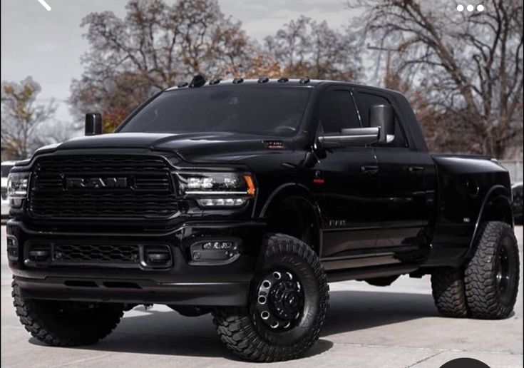 a large black truck parked in a parking lot