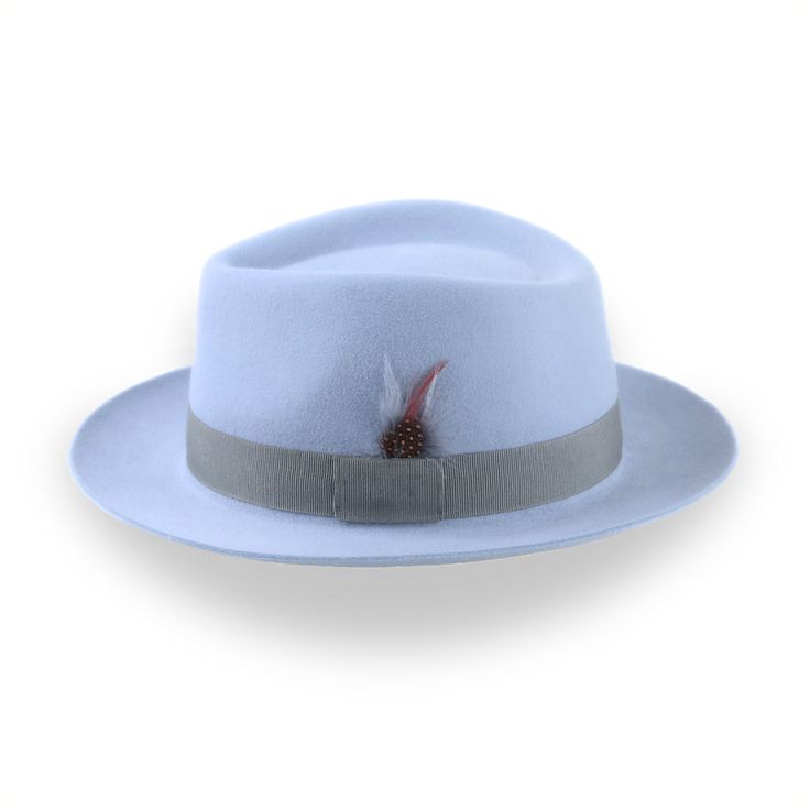 Description Materials Craftsmanship Hat Care Shipping Returns Product Description A Medium Crown Design for a Sleek Look Upgrade your style game with the Clubber, a light blue fur felt fedora that makes a bold statement. Crafted from luxurious fur felt, this hat features a medium crown and is adorned with a sleek grey grosgrain ribbon band, complete with a stylish feather. Whether you're dressing up for a night out or adding a touch of sophistication to your everyday look, the Clubber is versati Mens Felt Hats, Spanish Hat, Homburg Hat, 1940 Style, Gambler Hat, Mens Hats Fashion, Fedora Hat Men, Homburg, Chapeau Cowboy