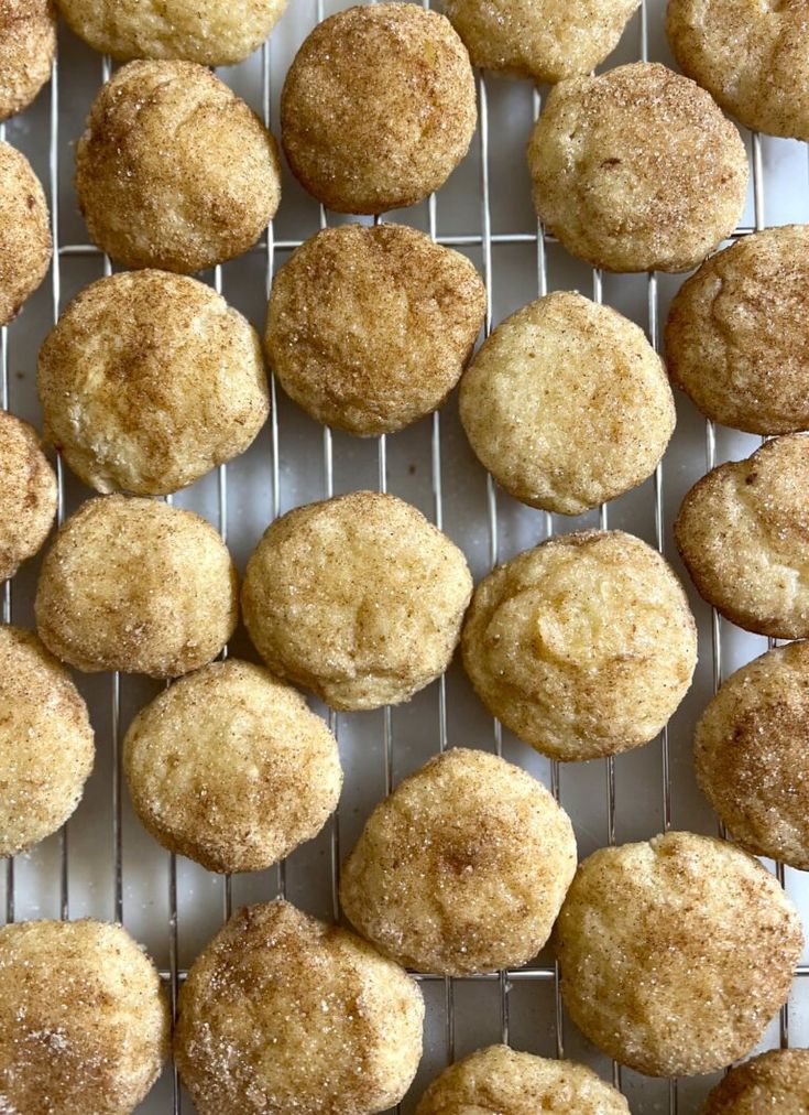 some sugared donuts are on a cooling rack and ready to be baked in the oven