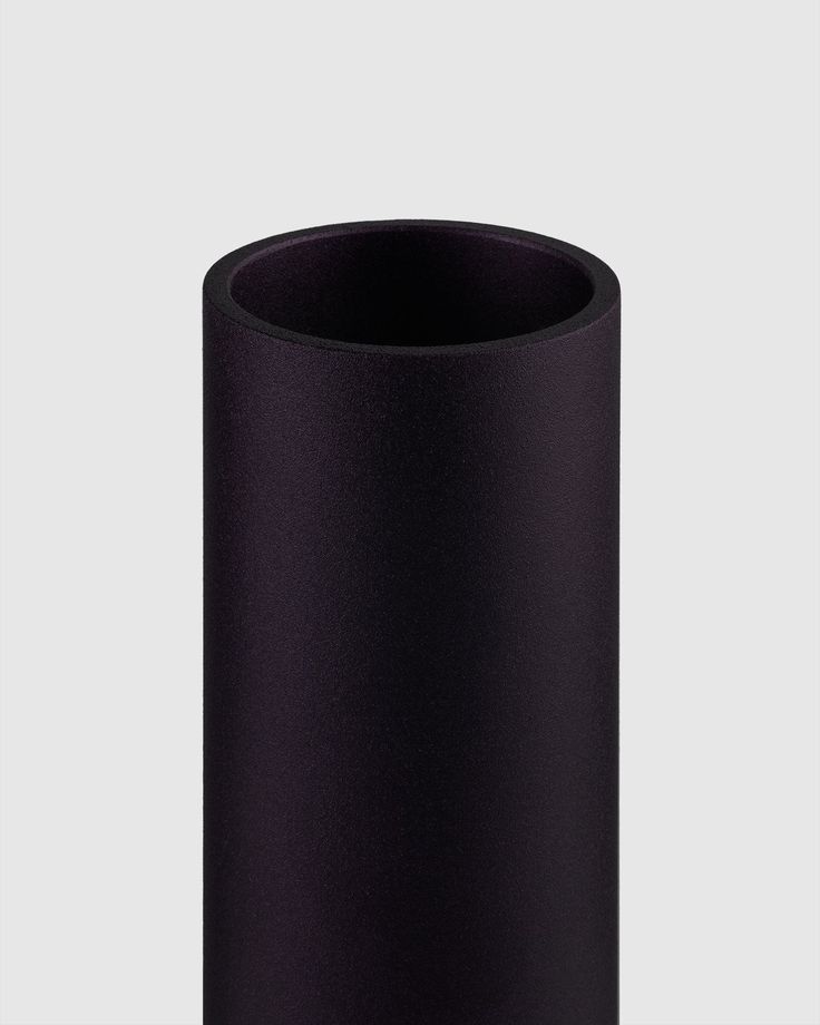 a black vase sitting on top of a table