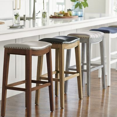 three stools are lined up in front of an island