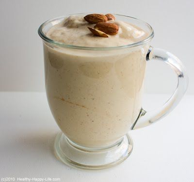 a glass mug filled with pudding and topped with almonds