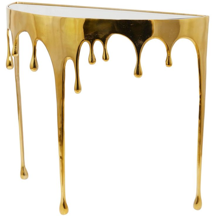 a gold console table with dripping paint on it