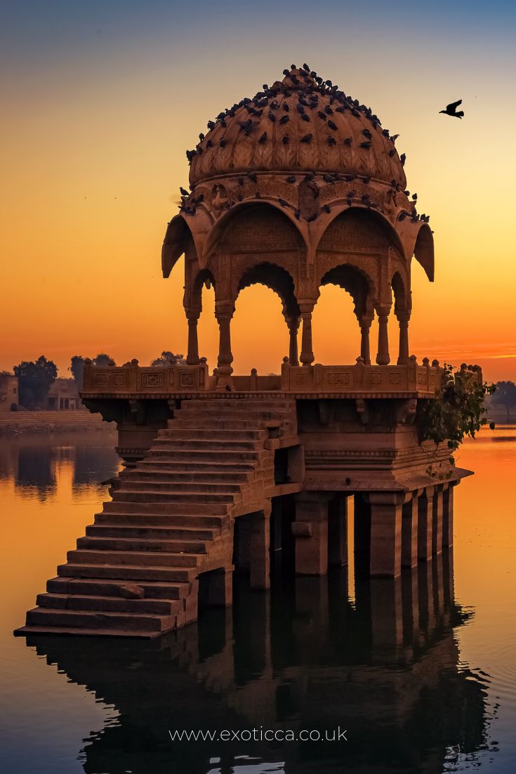 a gazebo sitting on top of a body of water with steps leading up to it