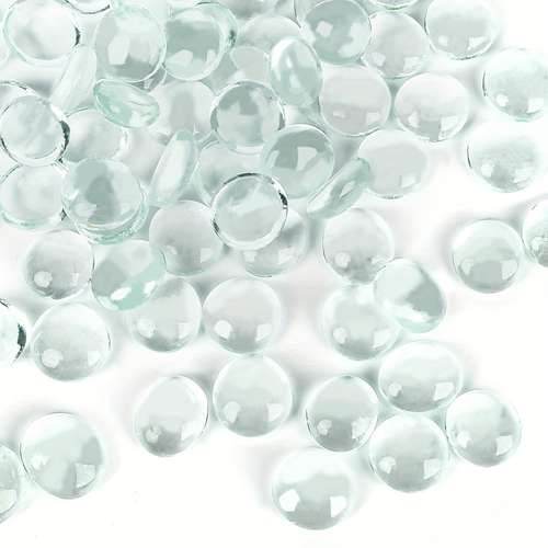 clear glass beads are scattered on a white surface