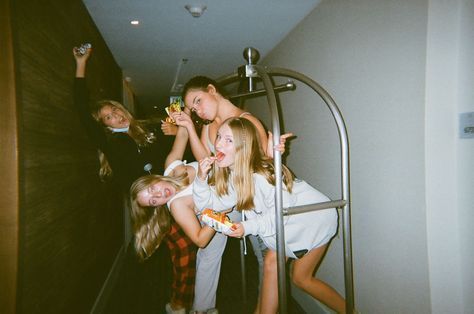 three girls are standing on the stairs and one girl is holding something in her hand