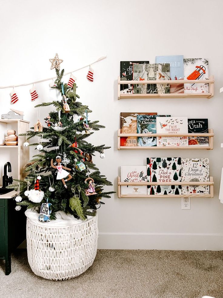 a small christmas tree in a white basket next to bookshelves with american flags on them