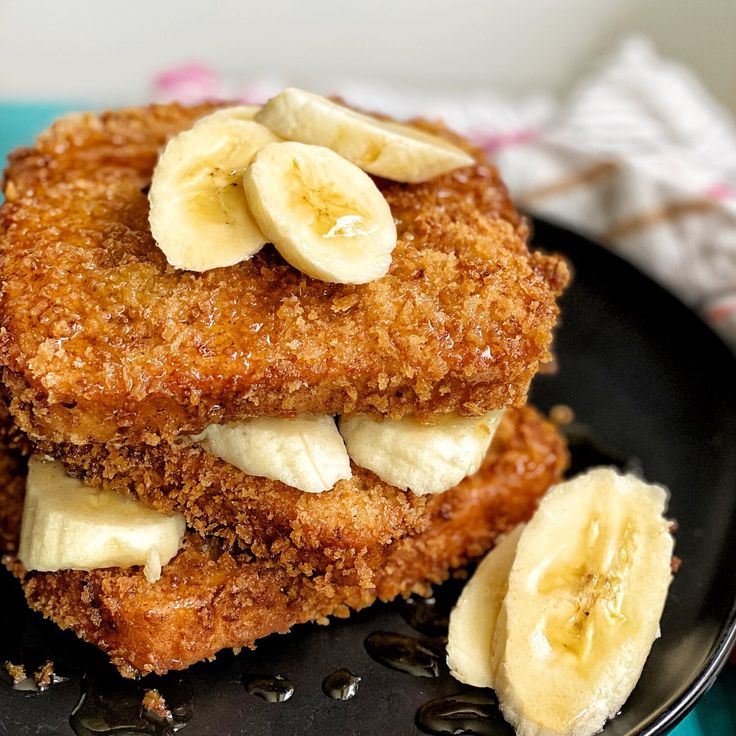 two pieces of fried bread with bananas on top