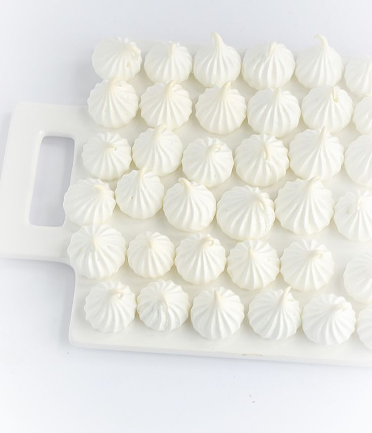 there are many white shells on the tray