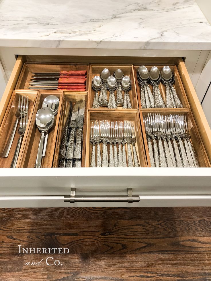 an open drawer filled with silverware and utensils