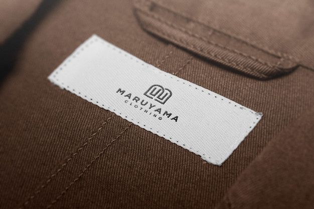 the label on a brown suit with white stitching