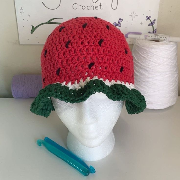 "Introducing the Crochet Watermelon Bucket Hat! This refreshing and whimsical accessory is a sweet treat for your style. Handcrafted with care, it showcases the iconic watermelon pattern with juicy red and green hues, completed by black \"seeds\" for an authentic touch. Whether you're lounging by the pool or exploring the farmer's market, this hat is the perfect blend of fashion and fun. Embrace the summer vibes and stay cool under the sun with this delightful watermelon crochet bucket hat! 🍉🧶" Watermelon Crochet, Crochet Watermelon, Whimsical Accessories, Watermelon Pattern, Crochet Bucket, Crochet Bucket Hat, Green Hues, Farmer's Market, Bucket Hats