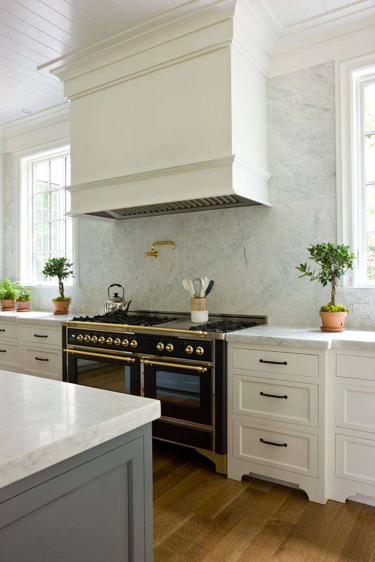 a kitchen with an oven, stove and counter tops in white painted wood flooring