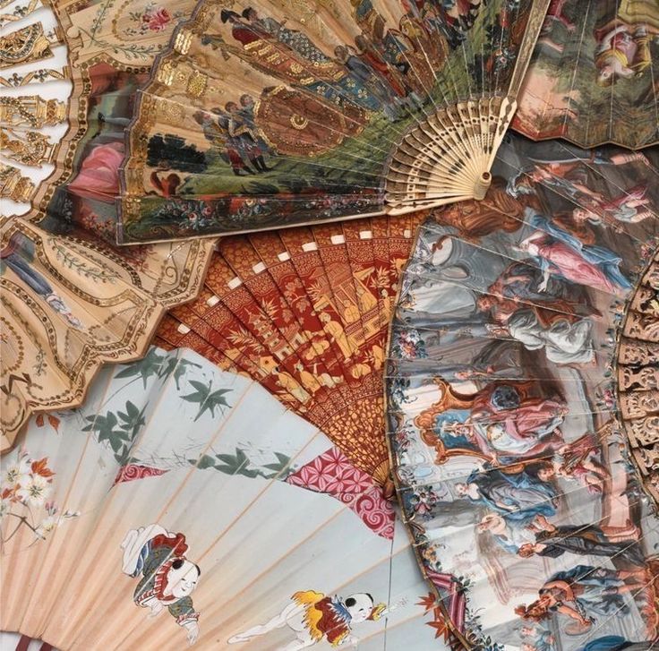 an assortment of decorative hand fan's on display