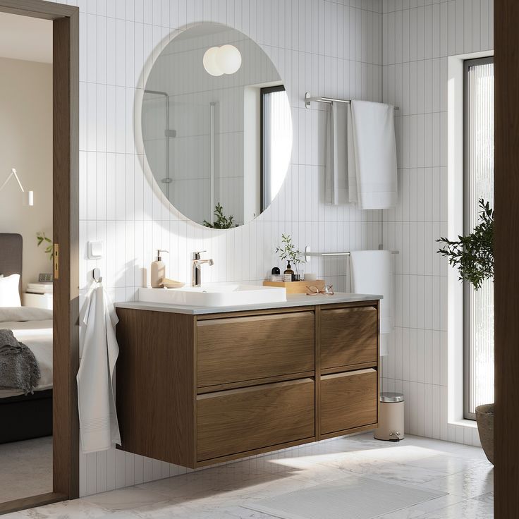 a bathroom with a sink, mirror and bathtub in the middle of the room