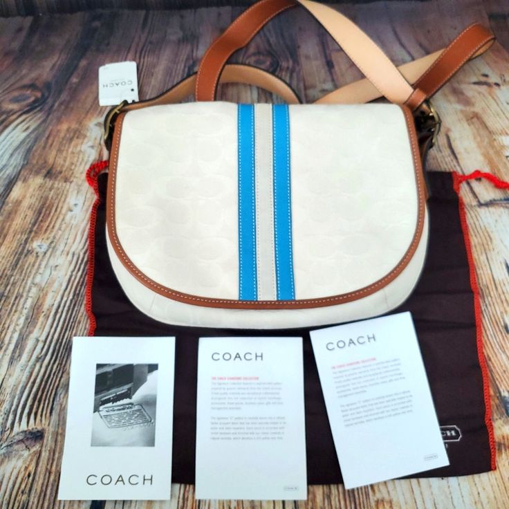 Coach Ivory Canvas Signature Bag New With Tags. Dust Bag And Care Card Included. Color: Ivory, Blue Middle Stripe And Brown Leather Trim. 1 Interior Zip Pocket. 1 Back Slip Picket. 9 1/2" Width X 10 1/2" High Feel Free To Visit My Page Or Follow Me To See Other Items On Sale. G449 Pink Coach Purses, Navy Crossbody Bag, Ashley Black, Coach Crossbody, Buckle Bags, Black Leather Crossbody Bag, Signature Canvas, Vintage Coach, Leather Buckle