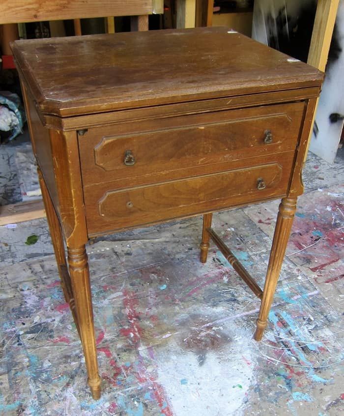 an old wooden table with paint all over it