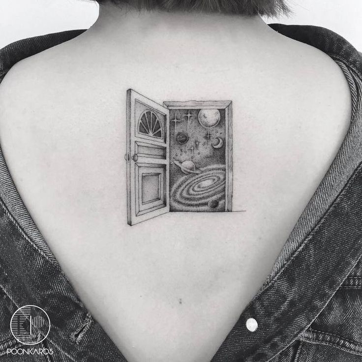 an open door tattoo on the back of a woman's upper arm and shoulder